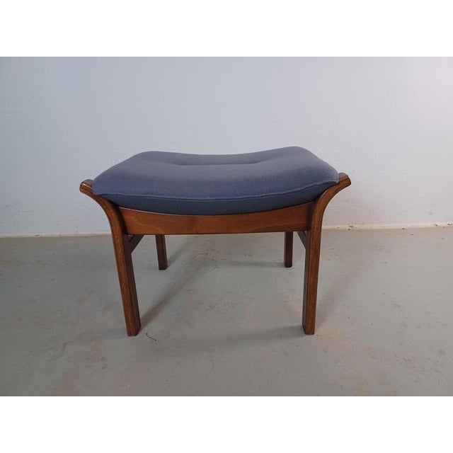 1970's Danish beech footstool with blue fabric upholstery. Danish footstool in slimlined but advanced Scandinavian modern...
