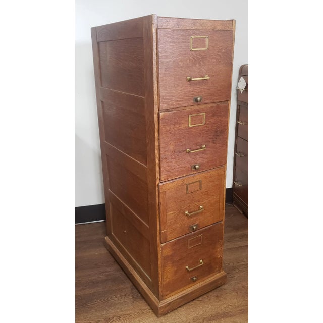 1920s oak panelized four drawer file cabinet. Heavy duty. Had been refinished and looks great with age patina. All drawers...