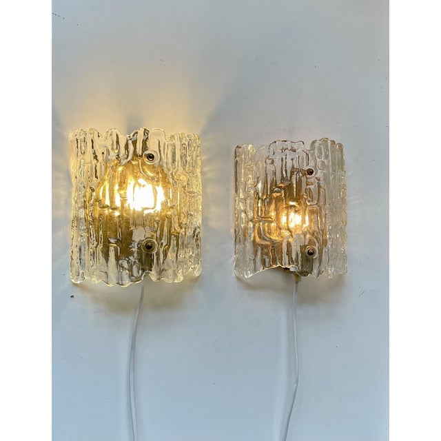 Fagerlund Ice wall lights manufactured by Orrefors in Sweden during the 1960s. The textured crystal glass shading creates...