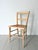 A charming pair of pale oak chairs with turned spindle legs and caned seats. The pretty detailing includes fine geometric...