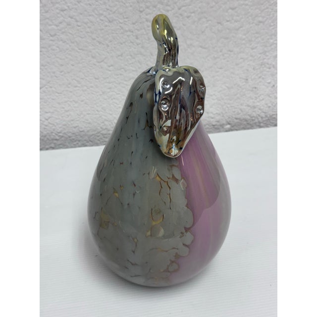Design Plus Gallery presents a Glass Pear Hand Blown Pear Shape by Lucy Chamberlain. The pear has colors of matte gray,...