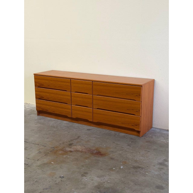 Authentic Danish Mid Century Modern teak dresser featuring a clean minimalist design and beautifully sculpted integrated...