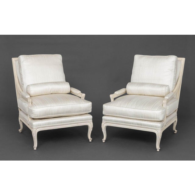 Pair of Louis XVI Style White Painted Wood Fauteuils, with silk-blend white upholstered cushions and lumbar pillows. 35.5"...