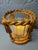 A pair of gilt metal candle holders in the neoclassical rope-and-tassel manner, each with a fluted glass votive insert....