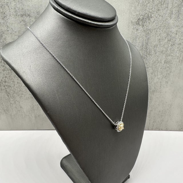 This stunning Natural Yellow Diamond Pendant Necklace in 14kt gold features a 0.67ctw natural fancy light yellow cushion-...