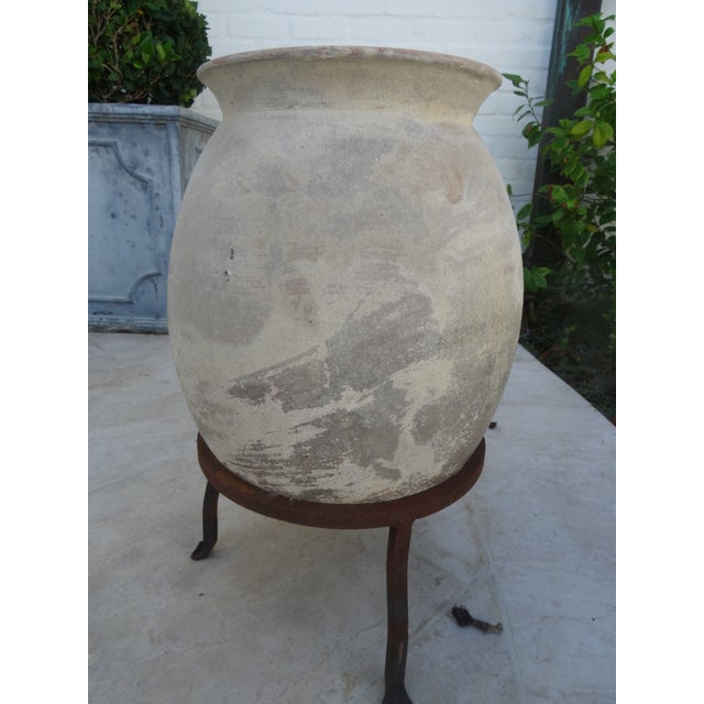 A beautiful Terra Cotta Oil Jar on Iron Stand from the Mid 20th Century.