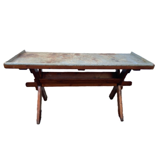 Very unique, French, large, tin-wrapped wood potting trestle table. - Rich brown colored wood is offset by the beautifully...