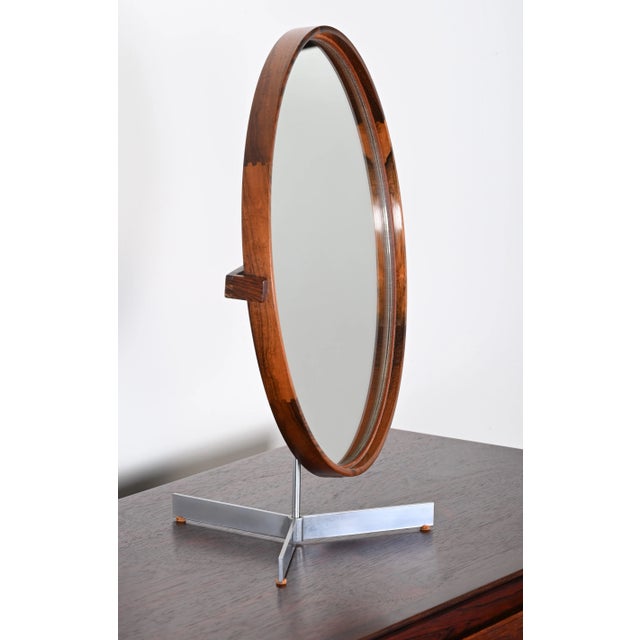 An elegant Uno & Östen Kristiansson Mirror Produced by Luxus in Vittsjö, Sweden. This beautiful rosewood mirror has great...