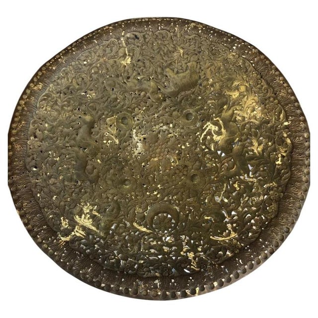 A striking 19th-century Indian brass decorative shield, dating from approximately 1850–1899, featuring an extensively...