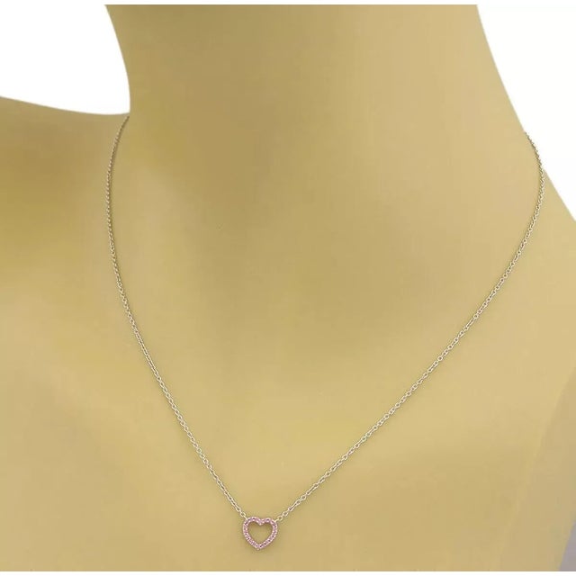 This is a lovely and elegant mini heart pendant and chain necklace from the house of Tiffany & Co. It is crafted from...