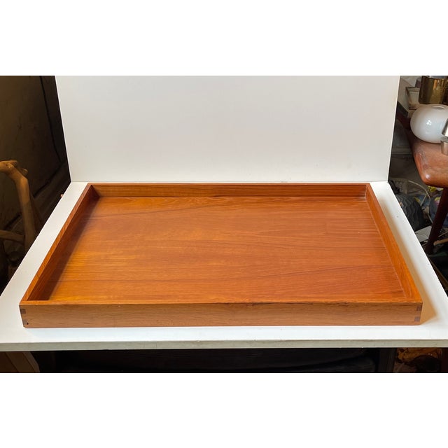 A large rectangular serving tray measuring 60x40x4.5 cm. Built as a tank with solid teak profiles with well-made dovetail...