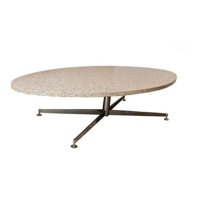 Large coffee table with a thick elliptical granite top and a stainless steel central base, designed by Michel Kin for...