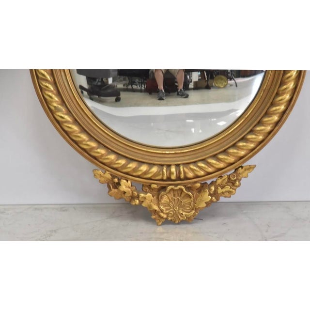 This is a 1940s Italian carved Giltwood Federal style round mirror distributed by the decorating firm FJ Newcomb out of...