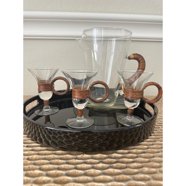 Fabulous vintage Carl Aubock style glass pitcher featuring iconic rattan/cane wrapped handle, attached glass underplate....