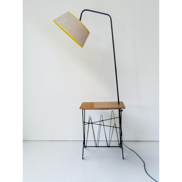 A charming 1950s floor lamp, cleverly combining lighting and storage in one simple design. The black lacquered steel rod...