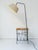 A charming 1950s floor lamp, cleverly combining lighting and storage in one simple design. The black lacquered steel rod...