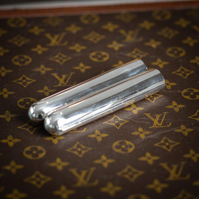 Antique early 20th century english solid silver cigar case. The case has a straight edge and rounded end with two...