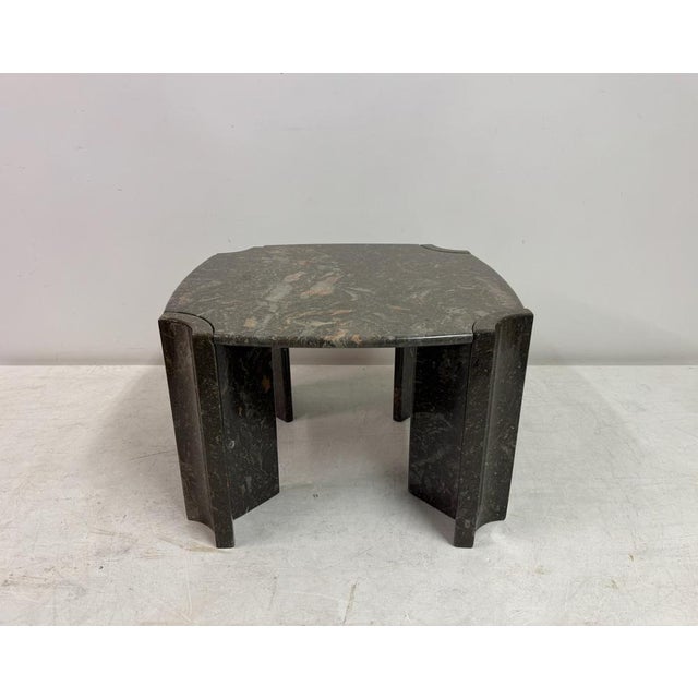 A striking octagonal centre or coffee table crafted entirely from richly patterned marble, notable for its sculptural form...