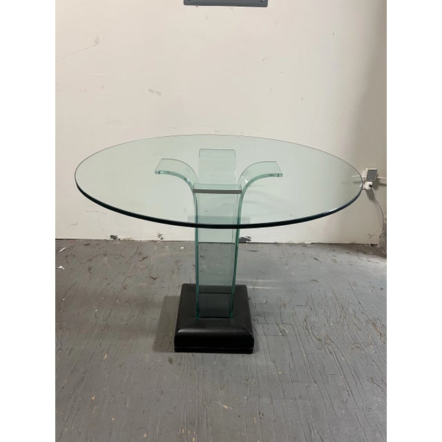 This stunning glass pedestal table by renowned designer John L. Mathias combines minimalist elegance with a striking...
