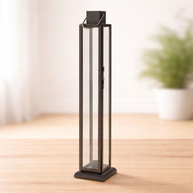 Elevate your décor with this Modern Iron and Glass Taper Candle Lantern. Designed with a sleek, elongated frame and clear...