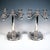 Two elegant five-flame candlesticks on a wide, round base with a flat, smooth top and a relief border on the sides,...