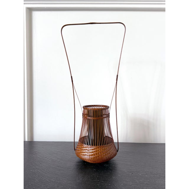 This small and delicate hand-woven ikebana basket (Hanakago) was made by Japanese Bamboo artist Jin Morigami (1955-) circa...