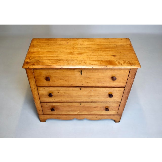 An American pine chest of three drawers, original locks and working key with scalloped apron. Very sweet and sturdy, circa...