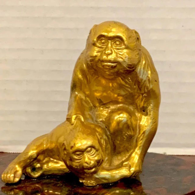 French gilt bronze sculpture of seated monkeys, nicely detailed, two expressive sitting primates, attached to an oval...