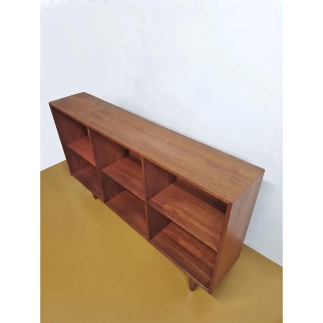 Vintage 1950s Danish teak bookcase with six open compartments, featuring a minimalist modular design perfect for mid-...