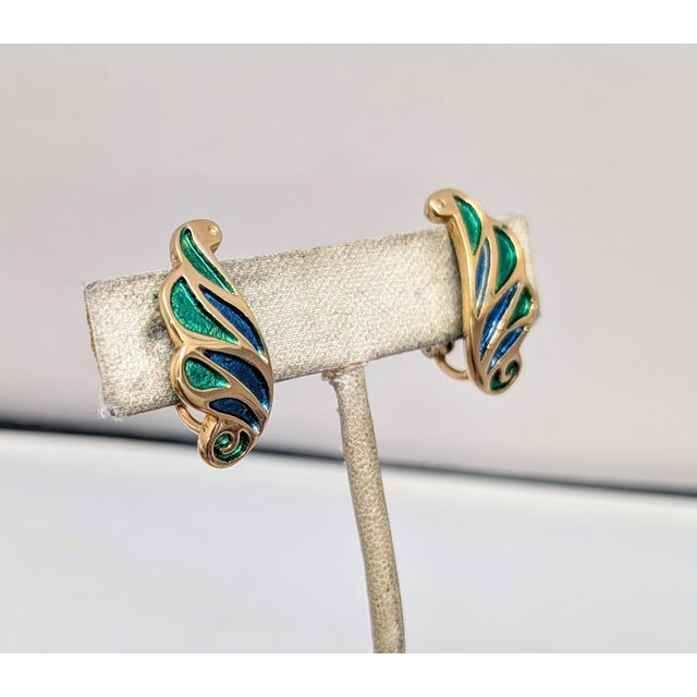 1960s goldtone green and blue enamel feather clip earrings. Marked "NAPIER" on the clips. Measure: 1 1/6 inches long by...