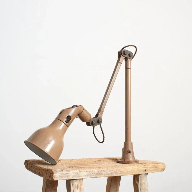 An original industrial lamp manufactured by mek elek. The lamp in finished in the scarcer taupe colour way. It can be...