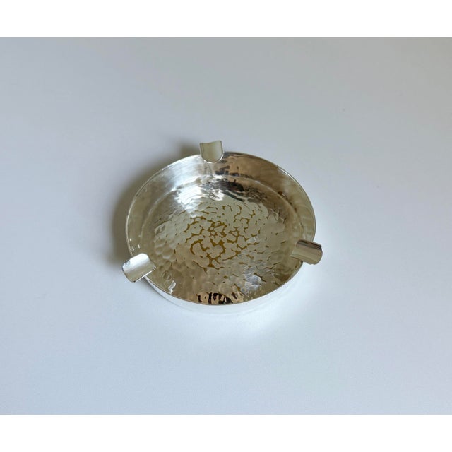 Rustic refinement in this rare hand-forged and hammered ashtray finished in silver-plate produced by Christofle. Between...