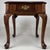 An elegant early 20th-century English side table, finely crafted from walnut and distinguished by its beautifully figured...