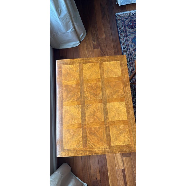 By Baker Furniture USA, Circa 1980s Carved walnut, with burl wood parquet top. Measures: Table 1: 22"W x 17"D x 22.25"H....