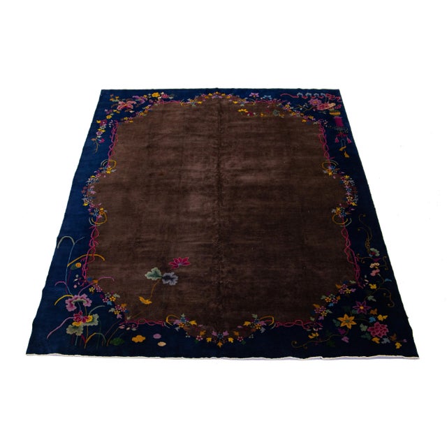 Beautiful antique Chinese Art Deco rug, hand-knotted wool with a brownfield. This rug has a blue frame and multi-color...