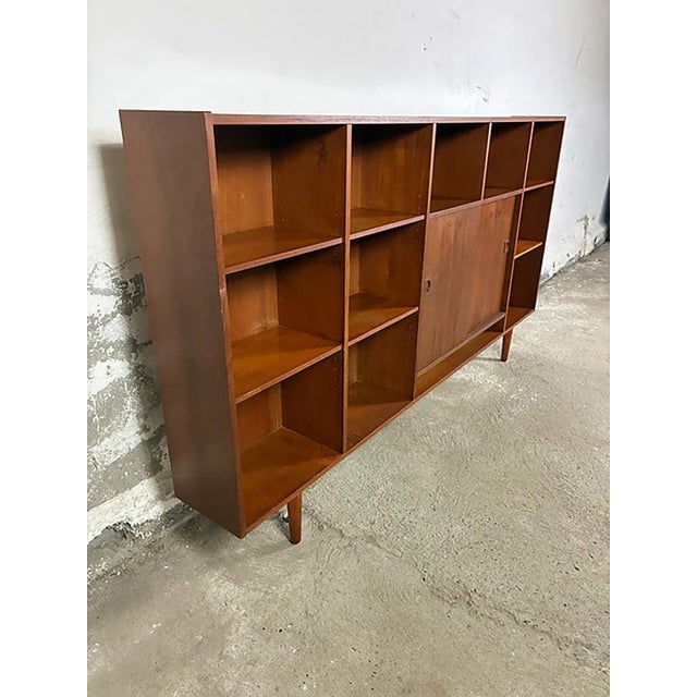 1950s danish teak bookcase with open shelves and sliding doors, 200cm 1950s danish teak wall/bookcase, 200cm wide, with...