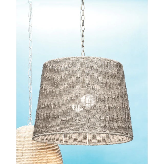 The simple silhoutte of this pendant places all the focus on the beautiful highs and lows of natural seagrass. Artisans...