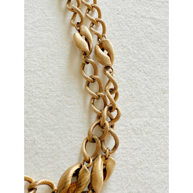 Vintage 1970s Napier gold tone brushed station chain necklace featuring a substantial elongated curb chain with sculptural...