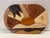 This handcrafted wooden piece is an example of intarsia or marquetry, where various types of natural wood are shaped and...