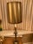 This is an Empire Revival brass column table lamp featuring neoclassical design elements. The original shade is in good...