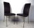 Sleek dining chairs in black vinyl with brass frames. Attractive curved back, simple modern design. Dimensions: 19w 19d...