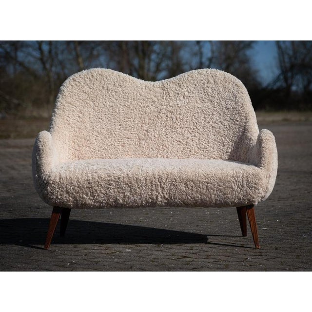 Two-seat sofa of unknown designer, crafted in the Swedish Modern style during the 1950s. Newly reupholstered in soft...