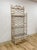 This gorgeous vintage Henry Link whitewashed rattan three-tier glass shelf etagere is a beautifully crafted and highly...