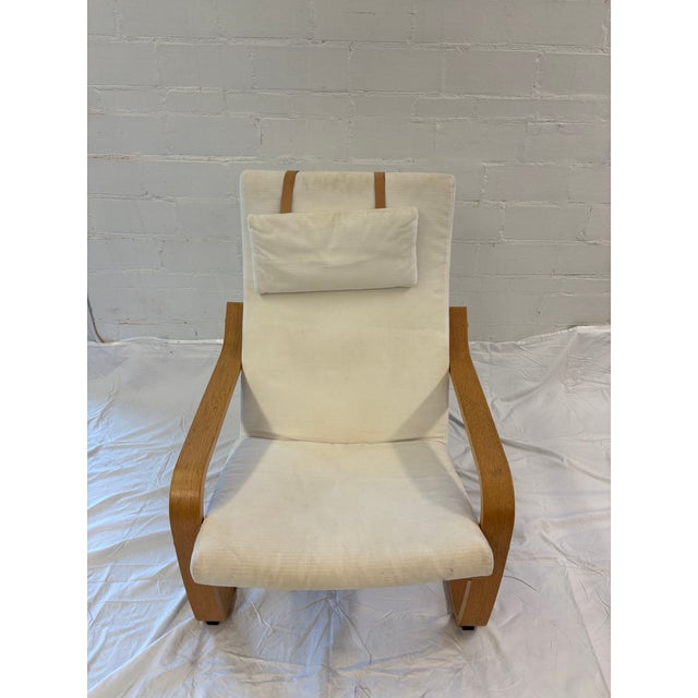 The iconic POÄNG lounge chair by IKEA, designed by Noboru Nakamura. Featuring the instantly recognizable bentwood frame...