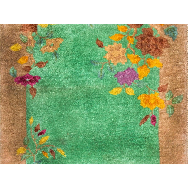 A fantastic early 20th century Chinese Art Deco rug with a mint green field surrounded by a tan undulating border overlaid...