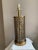 Hollywood Regency table lamp with an open, geometric lattice body made out of brass metal. Underneath the lattice work is...