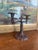 An intricately cast possibly 19th-century double-arm candelabrum in solid iron, featuring a richly detailed Rococo-...
