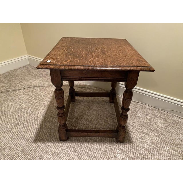 A small English oak joint stool or side table with a rectangular beveled edged top, four ring-carved and turned bulbous...