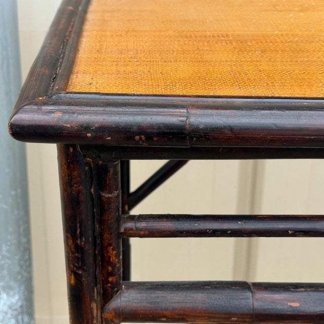 This is a pair of rattan console tables with Chinese Chippendale style console tables. They have grasscloth tops and a...