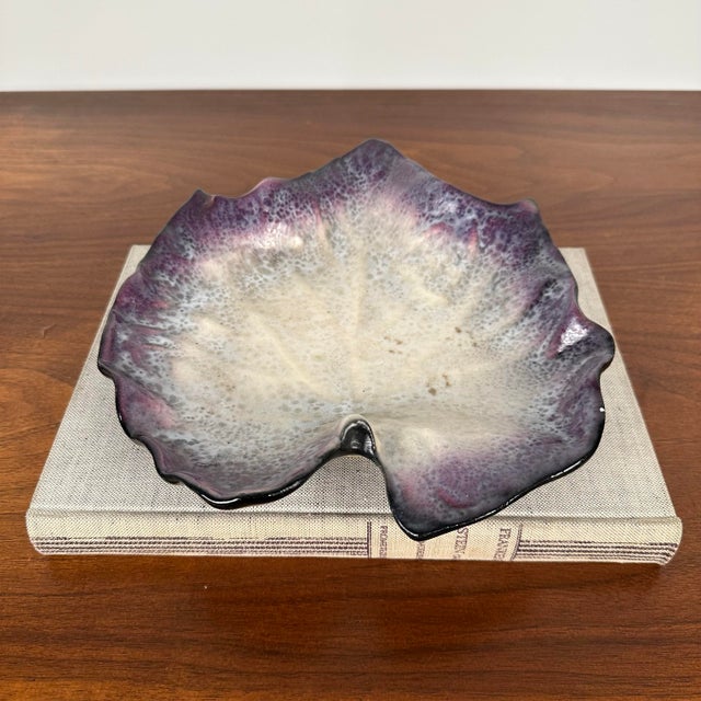 Glazed ceramic dish featuring a leaf motif in the colors of purple, blue, off white, and black. in Glazed Stonewar by Pol...